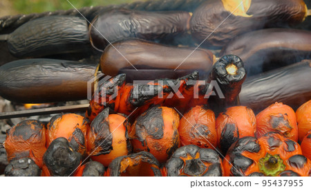 Close-up of vegetables on skewers roasting on the grill. Top view. Delicious and healthy food. A traditional Caucasian dish. Close-up of vegetables on skewers roasting on the grill. Top view. Delicious and healthy food. A traditional Caucasian dish. 95437955