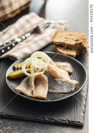 Marinated herring fish on plate. 95439376