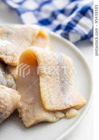Marinated herring fish on plate. 95439385