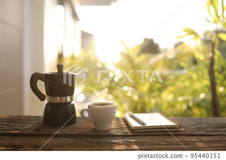 Black moka pot and white coffee cup and notebook Black moka pot and white coffee cup and notebook 95440151