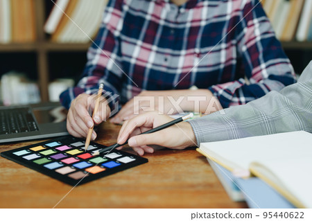 A group of professional web developer and graphic designer working together in the office. 95440622