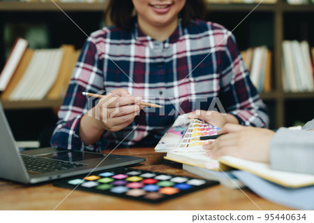 A group of professional web developer and graphic designer working together in the office. A group of professional web developer and graphic designer working together in the office. 95440634