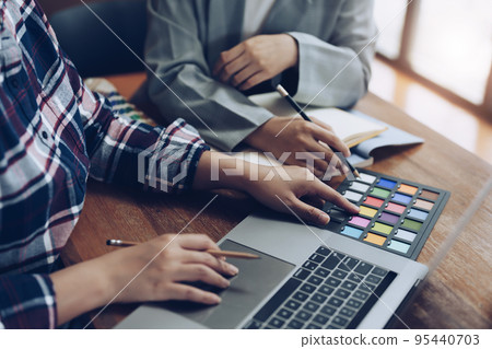 A group of professional web developer and graphic designer working together in the office. 95440703