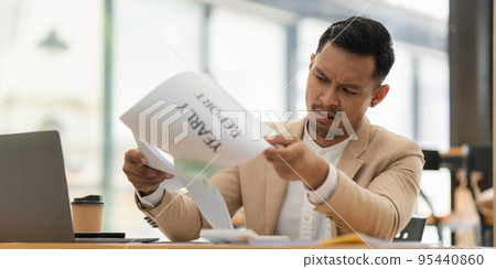 Stressed Asian businessman worry with many document on desk at office 95440860