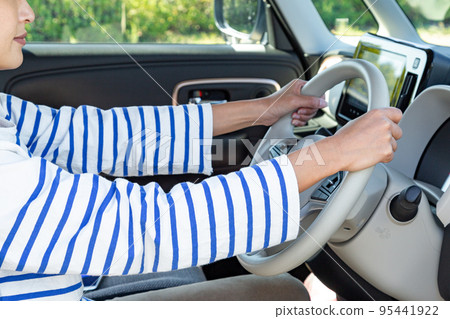 hand of a woman driving hand of a woman driving 95441922