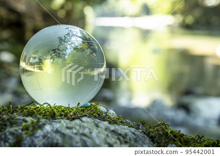 A clear stream flows in the background of a crystal globe centered on Japan A clear stream flows in the background of a crystal globe centered on Japan 95442001