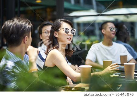 young asian adult friends gathering relaxing in outdoor coffee shop young asian adult friends gathering relaxing in outdoor coffee shop 95443076