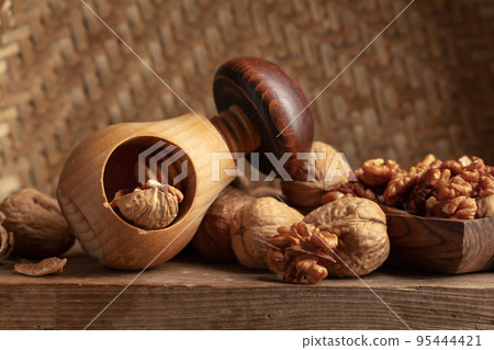 Walnuts on an old wooden table. 95444421