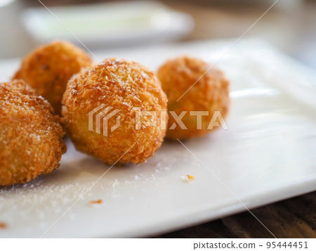 The cheese ball is on a white plate. with copy space. The cheese ball is on a white plate. with copy space. 95444451