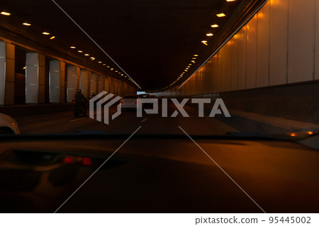 Man driving a car on a tunnel. Man driving a car on a tunnel. 95445002