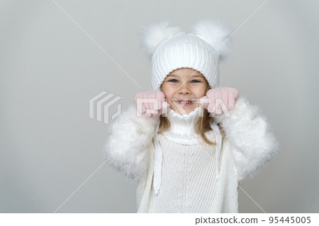 Portrait of beauty kid girl in wooly sweter and hat. Portrait of beauty kid girl in wooly sweter and hat. 95445005