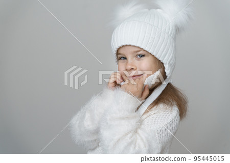 Portrait of beauty kid girl in wooly sweter and hat. Portrait of beauty kid girl in wooly sweter and hat. 95445015