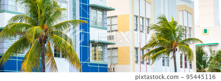 Closeup of typical colorful Art Deco architecture with tropical palm tree on Ocean Drive in South Beach, Miami, Florida, USA Closeup of typical colorful Art Deco architecture with tropical palm tree on Ocean Drive in South Beach, Miami, Florida, USA 95445116