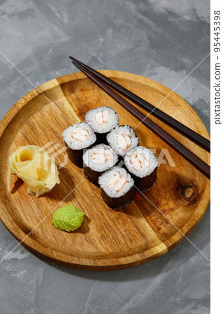 Traditional delicious freshsushi rolls with shrimp on a black background. Sushi roll with rice, cream cheese, avocado, salmon, sesame. Sushi menu. Japanese kitchen, restaurant 95445398