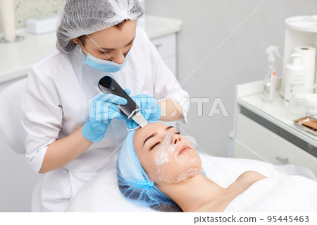 face of woman while procedure ultrasonic cleansing face of woman while procedure ultrasonic cleansing 95445463