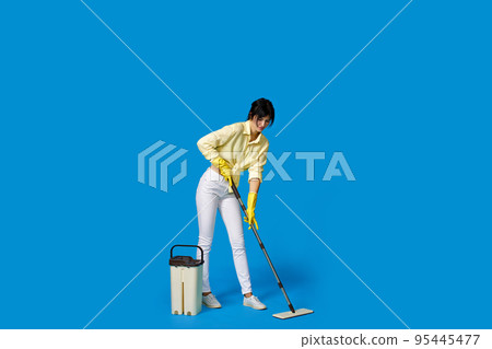 woman in rubber gloves with cleaning supplies 95445477