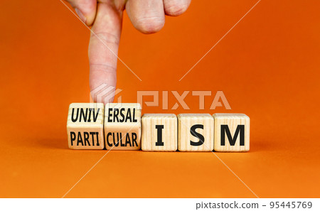 Universalism or particularism symbol. Concept words Universalism or Particularism on cubes. Businessman hand. Beautiful orange background. Business universalism or particularism concept. Copy space. 95445769