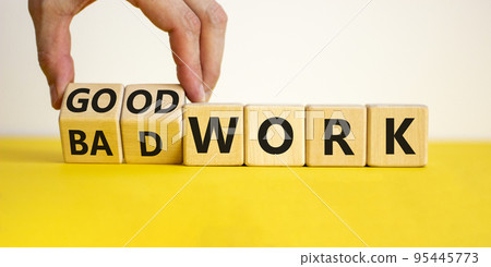 Good or bad work symbol. Businessman turns wooden cubes and changes words 'bad work' to 'good work'. Beautiful yellow table, white background, copy space. Business and good or bad work concept. Good or bad work symbol. Businessman turns wooden cubes and changes words 'bad work' to 'good work'. Beautiful yellow table, white background, copy space. Business and good or bad work concept. 95445773