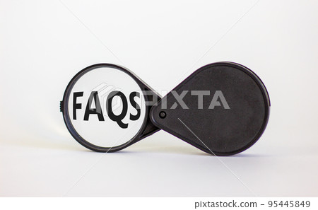 Magnifying glass with text 'FAQS' on beautiful white background. Business concept, copy space. 95445849