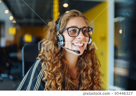 Meeting online. Young woman wearing headphones using laptop watching webinar or doing video chat. Meeting online. Young woman wearing headphones using laptop watching webinar or doing video chat. 95446327