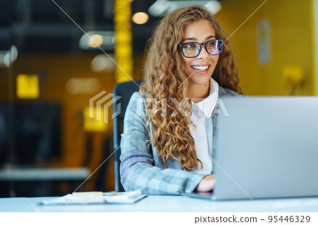 Call center agent with headset working on support hotline in modern office. Video conference. Call center agent with headset working on support hotline in modern office. Video conference. 95446329