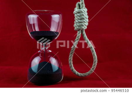 Hourglass and Hangmans Noose on a Mottled Red Background Hourglass and Hangmans Noose on a Mottled Red Background 95446510