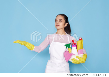 woman in rubber gloves pointing fingers aside at copyspace 95447111