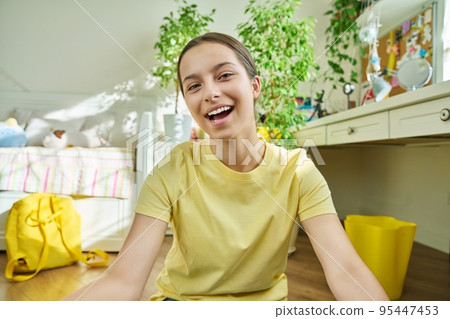 Adolescent teenage girl student having video call, looking at webcam 95447453