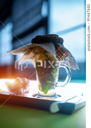 hot fresh vitamin green mint tea cup with pink sugar on wooden board hot fresh vitamin green mint tea cup with pink sugar on wooden board 95447680