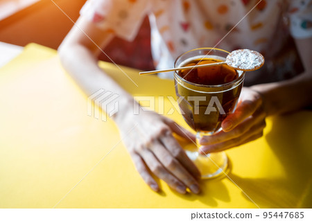 female drink brown cube libre cocktail with cola, brandy, rum or whiskey in cafe female drink brown cube libre cocktail with cola, brandy, rum or whiskey in cafe 95447685