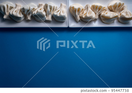 traditional georgian khinkali dumplings flatlay with copyspace, blue background traditional georgian khinkali dumplings flatlay with copyspace, blue background 95447738