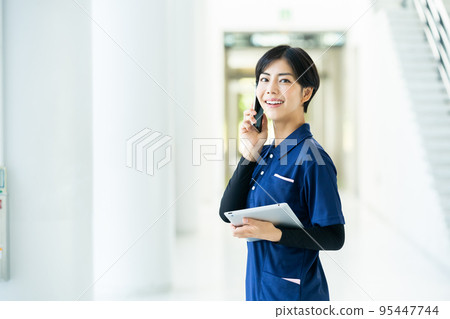 Caregiver operating a tablet Caregiver operating a tablet 95447744