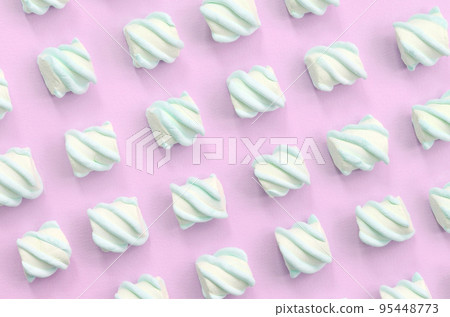 Colorful marshmallow laid out on pink paper background Colorful marshmallow laid out on pink paper background 95448773