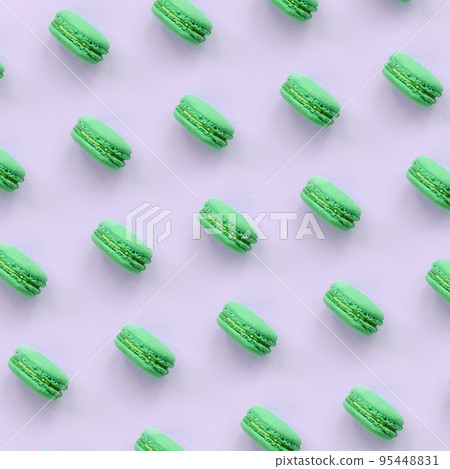 Green dessert cake macaron or macaroon on trendy pastel lilac background top view Green dessert cake macaron or macaroon on trendy pastel lilac background top view 95448831