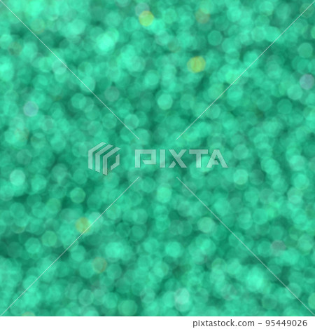 A huge amount of green decorative sequins. Blurred background image with shiny bokeh lights from small elements that reflect light in a random order 95449026