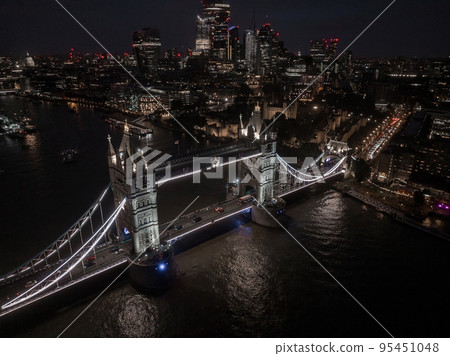 Aerial view to the illuminated Tower Bridge and skyline of London, UK, just after sunset at night time. Aerial view to the illuminated Tower Bridge and skyline of London, UK, just after sunset at night time. 95451048