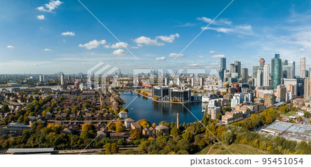 Aerial panoramic skyline view of Canary Wharf, the worlds leading financial district in London, UK. Business center of London. Aerial panoramic skyline view of Canary Wharf, the worlds leading financial district in London, UK. Business center of London. 95451054