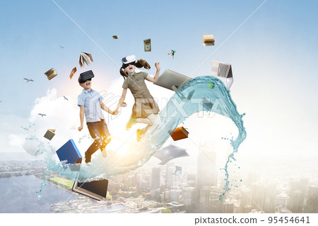Kids wearing virtual reality goggles 95454641