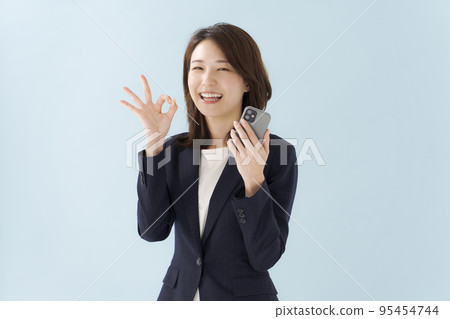 A woman in a suit blue background 95454744
