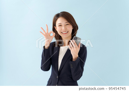 A woman in a suit blue background 95454745