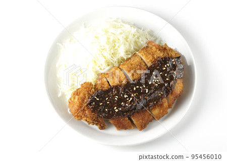 Overhead shot of shredded pork cutlet and cabbage with miso-based sauce on white background Overhead shot of shredded pork cutlet and cabbage with miso-based sauce on white background 95456010