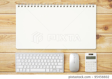 Bird's-eye view of a desk with a plain notebook Bird's-eye view of a desk with a plain notebook 95456602