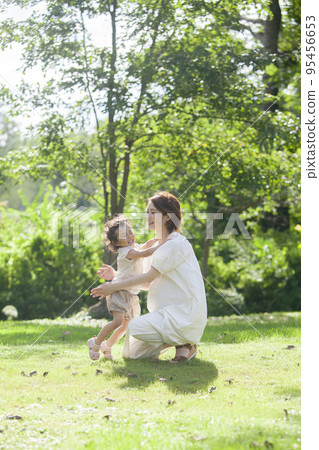 Pregnant mother hugging her child Pregnant mother hugging her child 95456653
