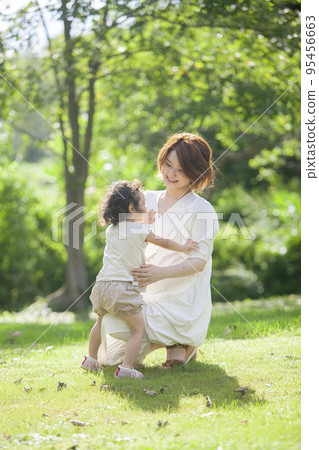 Pregnant mother hugging her child Pregnant mother hugging her child 95456663