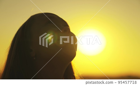 religion way life. child's face against background sunset sky. portrait teenager looking up. girl thinks dreaming. concept children dream. youthful silhouette child girl. daughter asks achieve dream. religion way life. child's face against background sunset sky. portrait teenager looking up. girl thinks dreaming. concept children dream. youthful silhouette child girl. daughter asks achieve dream. 95457718