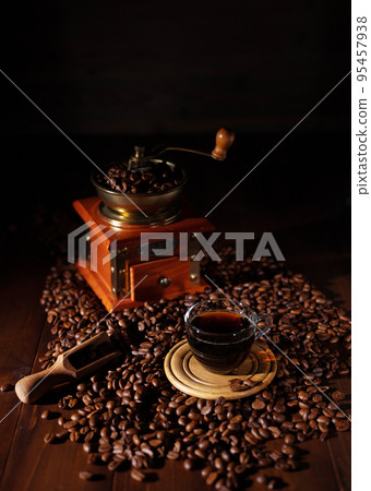 Cup of coffee and beans at wood table. Homemade coffee at table 95457938