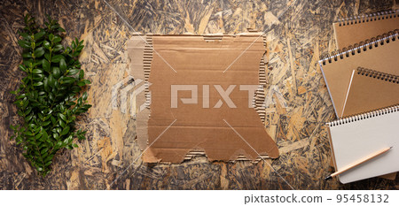 Cardboard torn edge and brown ripped paper on chipboard plywood background. Recycling concept Cardboard torn edge and brown ripped paper on chipboard plywood background. Recycling concept 95458132