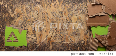 Cardboard torn edge and recycle symbol on chipboard plywood background texture 95458133