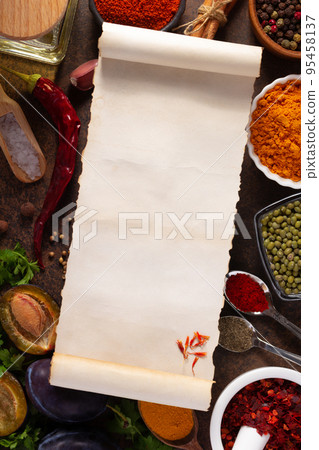 Variety of spices and herbs with cookbook paper at table background 95458137