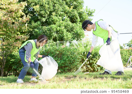 Young men and women picking up trash Volunteer cleaning image 95458469